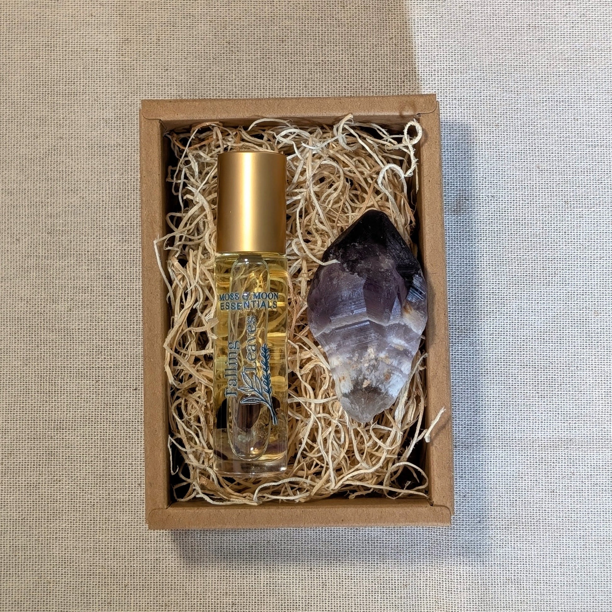 rollerball perfume with amethyst crystal in a gift box